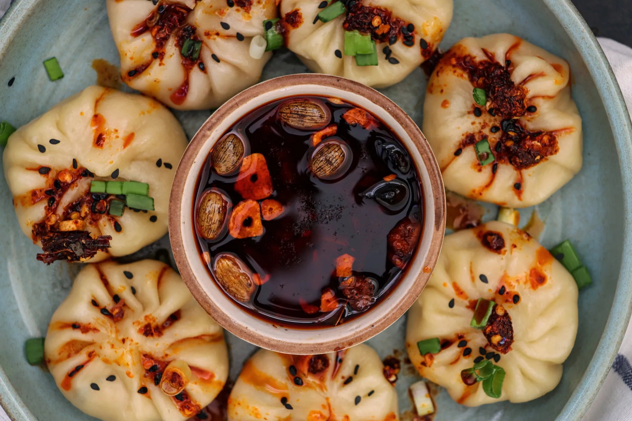 Steamed momos with dipping sauce